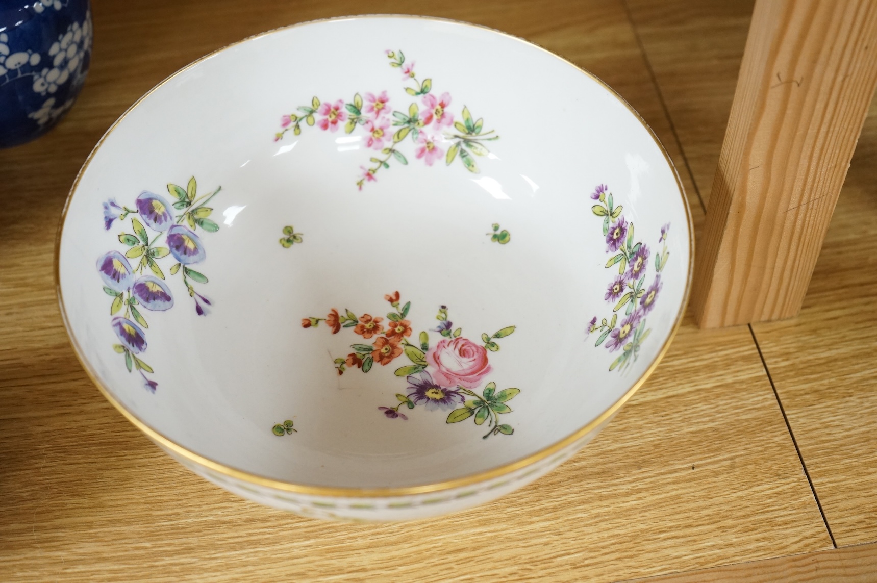 A Continental copy of a Bristol Champions bowl, rose and gilt decorated, 23cm diameter.